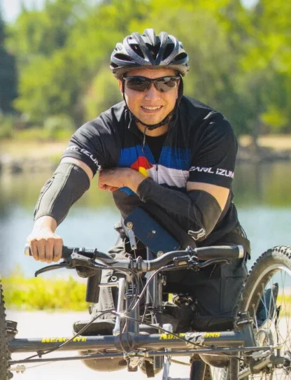 David Ortiz for State Rep. campaign image. Man on adaptive bike with "Never Give Up." Political branding photography by Paul Trantow.