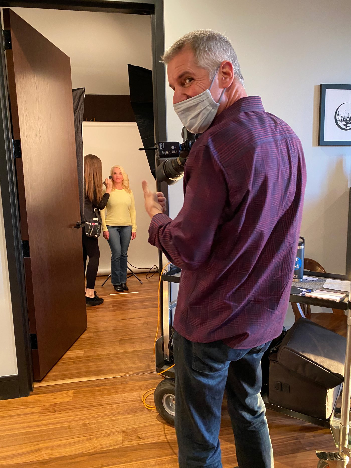 Behind the scenes brand photography: Woman getting makeup applied before a photoshoot.