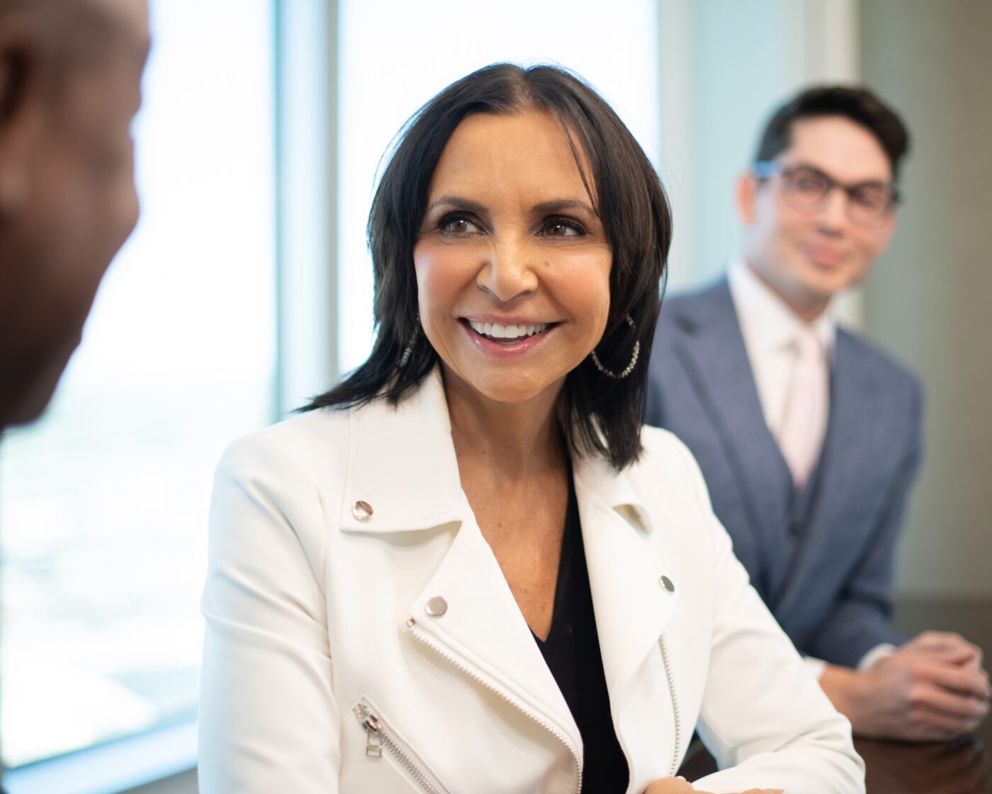 Professional branding portrait of a smiling businesswoman in a meeting in Denver Colorado.