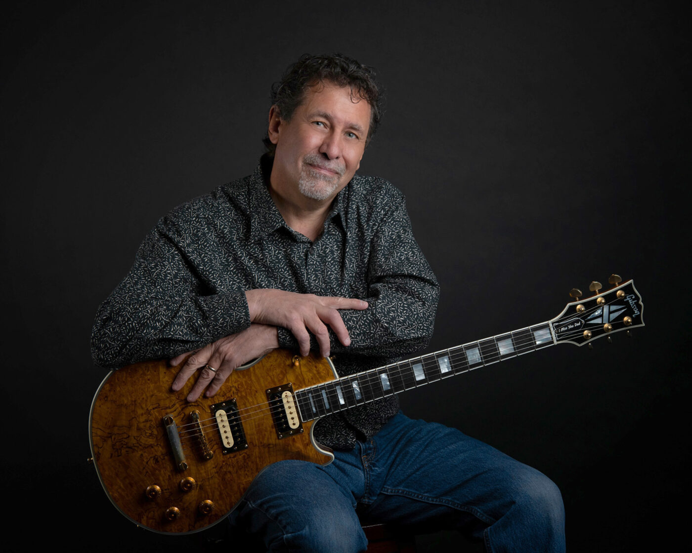 Ernie Santella, Denver videographer, with a beautiful guitar, brand photography by Altitude Arts.