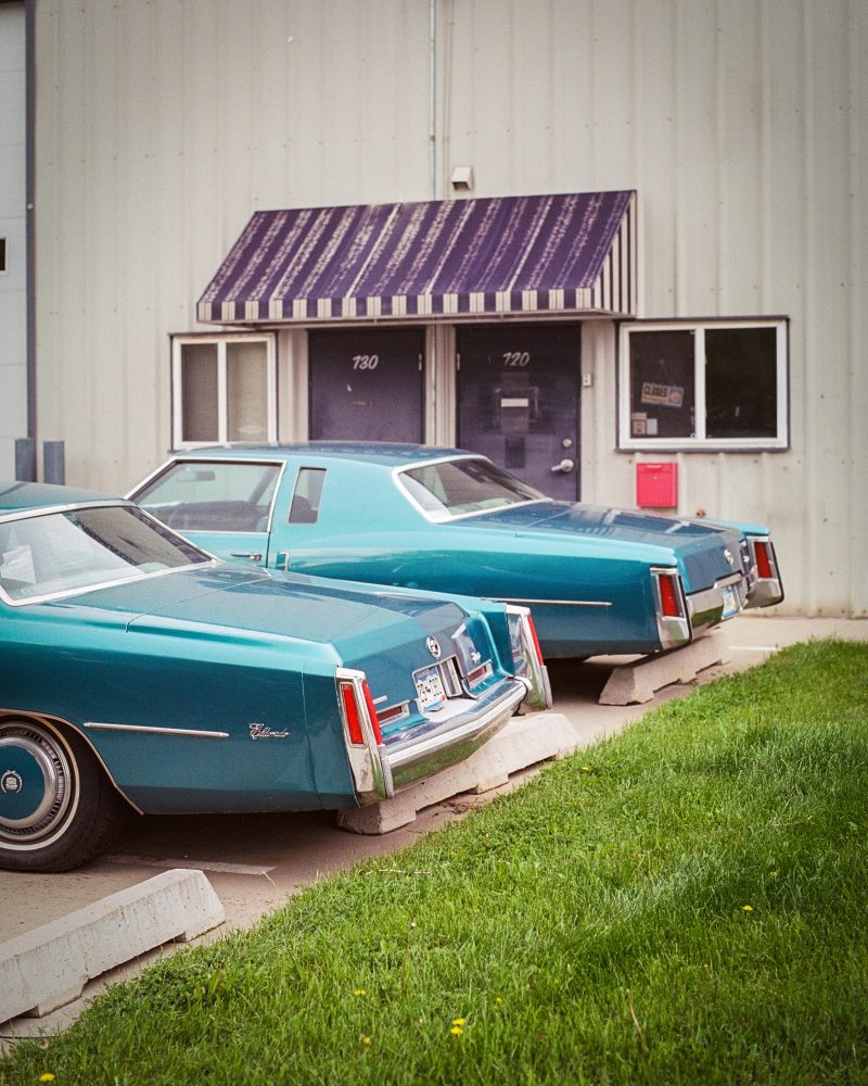 vintage red and white car in front of old motel