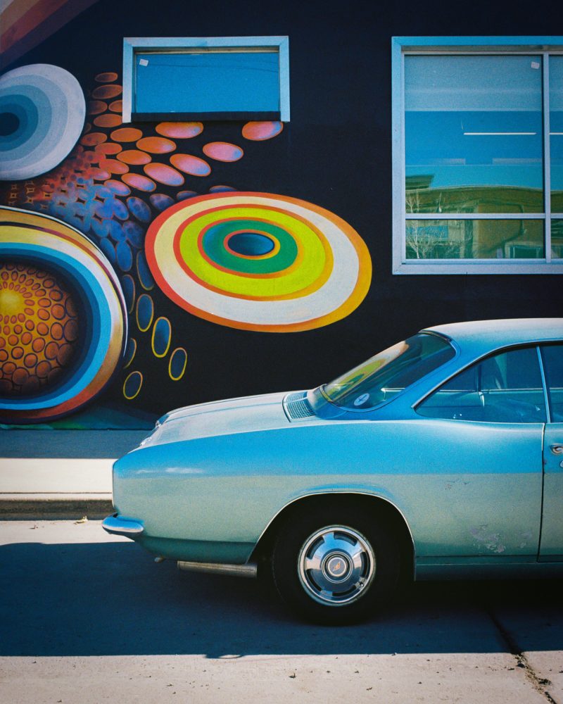 vintage red and white car in front of old motel