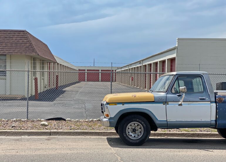 vintage red and white car in front of old motel