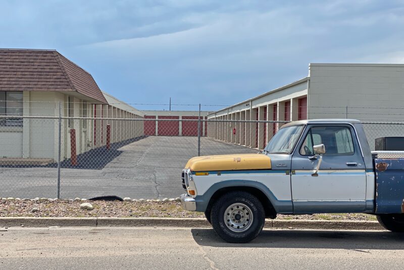 vintage red and white car in front of old motel