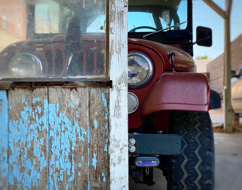 vintage red and white car in front of old motel