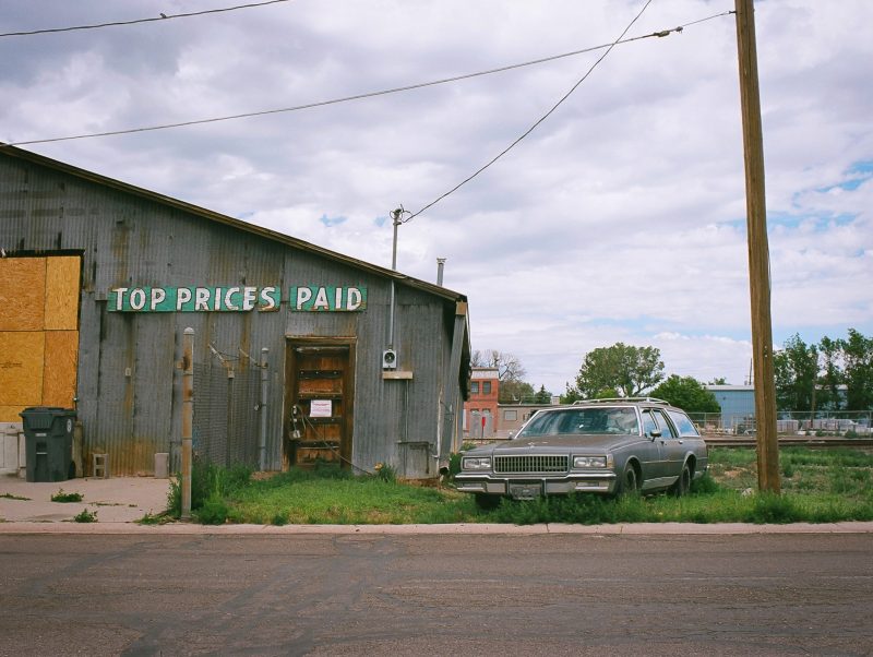 vintage red and white car in front of old motel
