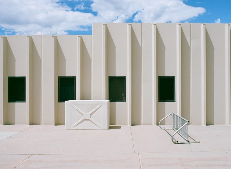 vintage red and white car in front of old motel
