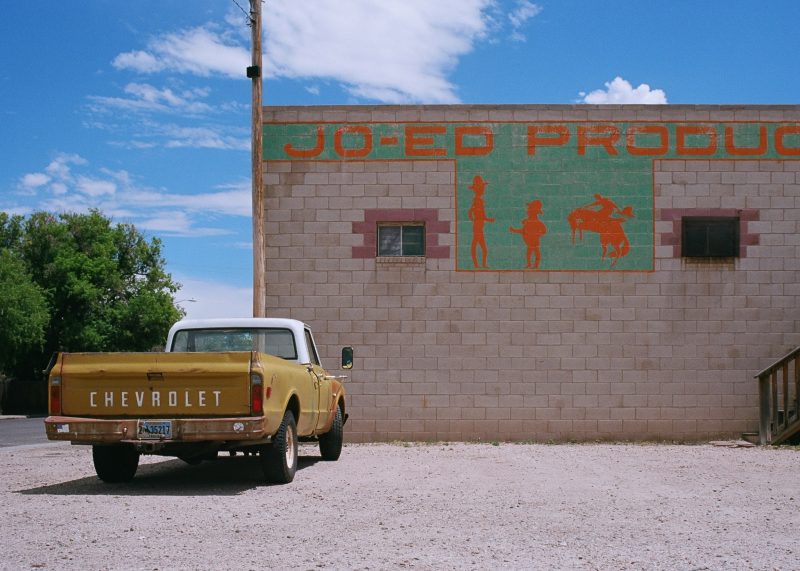 vintage red and white car in front of old motel