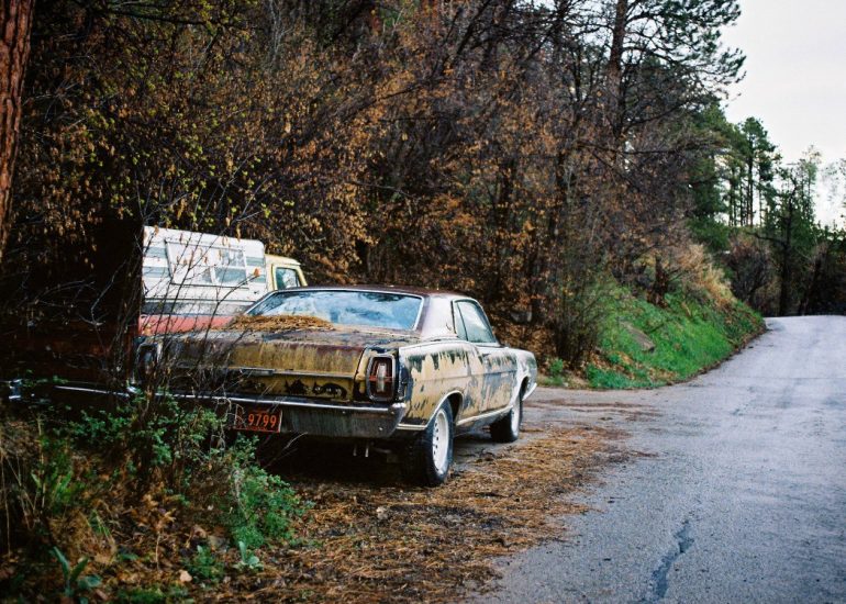 vintage red and white car in front of old motel
