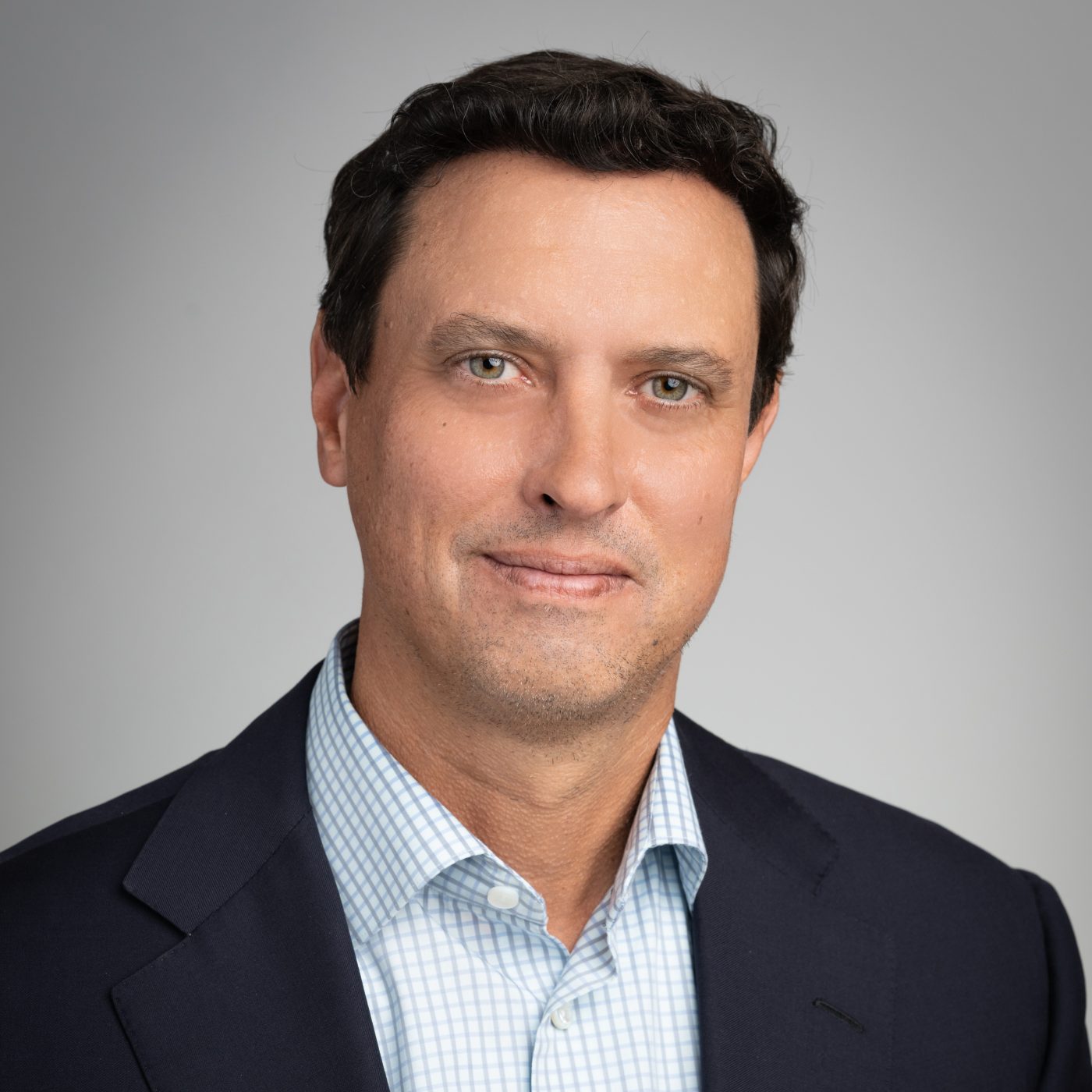 team headshot of male executive on grey background