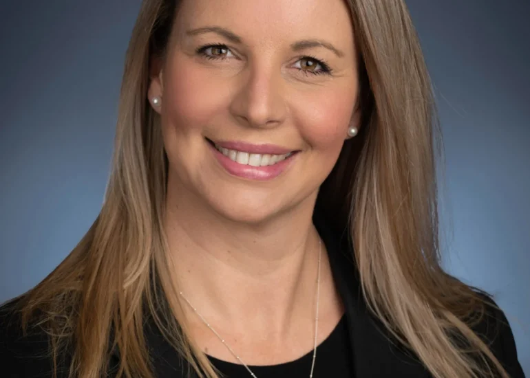 photography of female executive on blue backdrop - what to wear for a professional headshot
