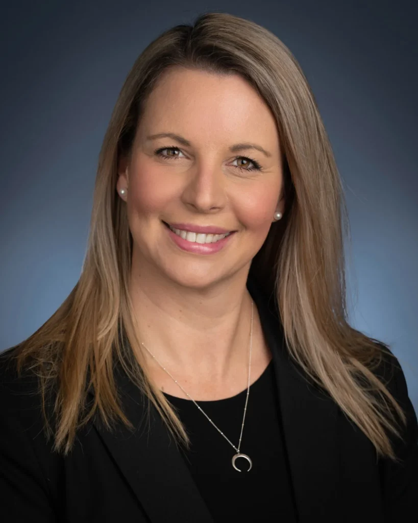 photography of female executive on blue backdrop - what to wear for a professional headshot